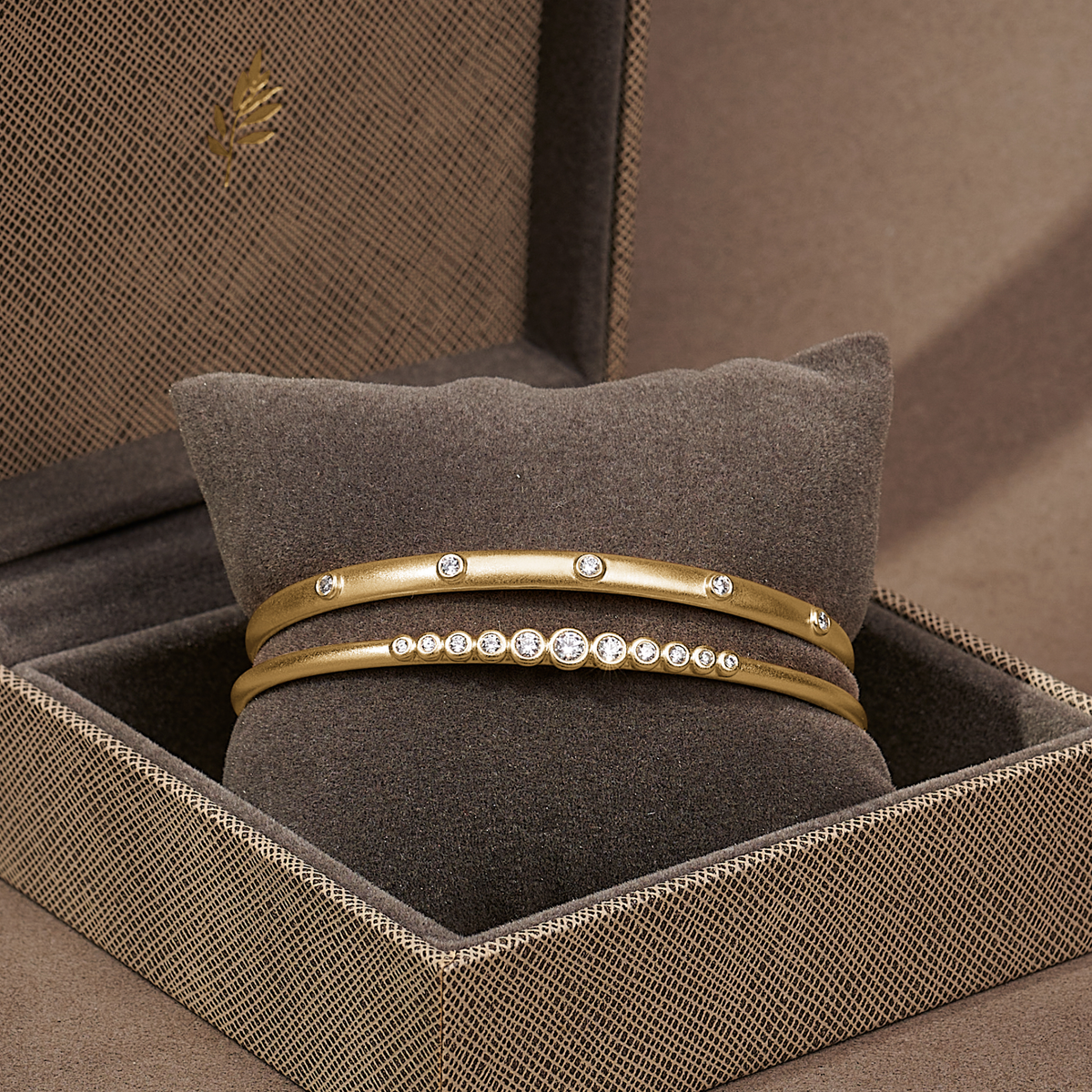 Grace Bangle i forgylt solv, vist i Julie Sandlau-gaveboks sammen med en annen bangle