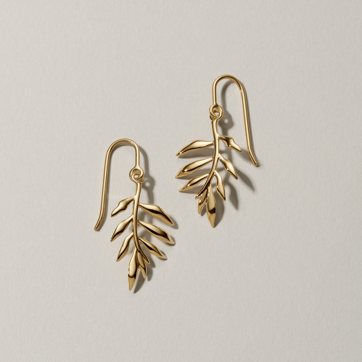 Tree of Life øredobber i 18K gull, bladformet design, flatlay